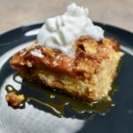 bread pudding on plate with whipped cream