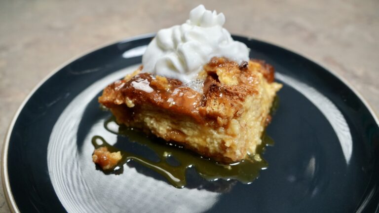 bread pudding on plate with whipped cream