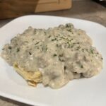 biscuits and gravy on a white plate