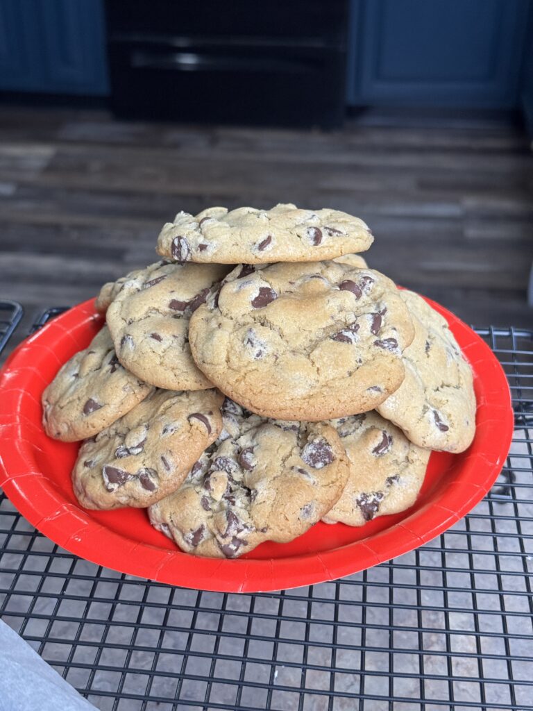 red plate full of chocolate chip cookies