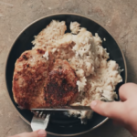 pork chop casserole on a black plate