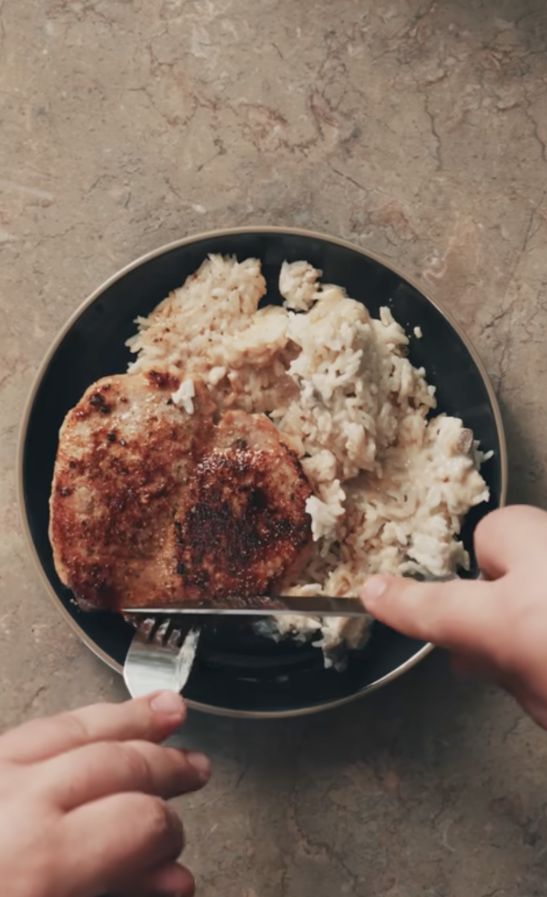 pork chop casserole on a black plate