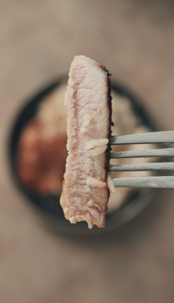 piece of pork chop on fork