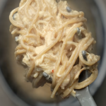 Italian chicken on large serving spoon