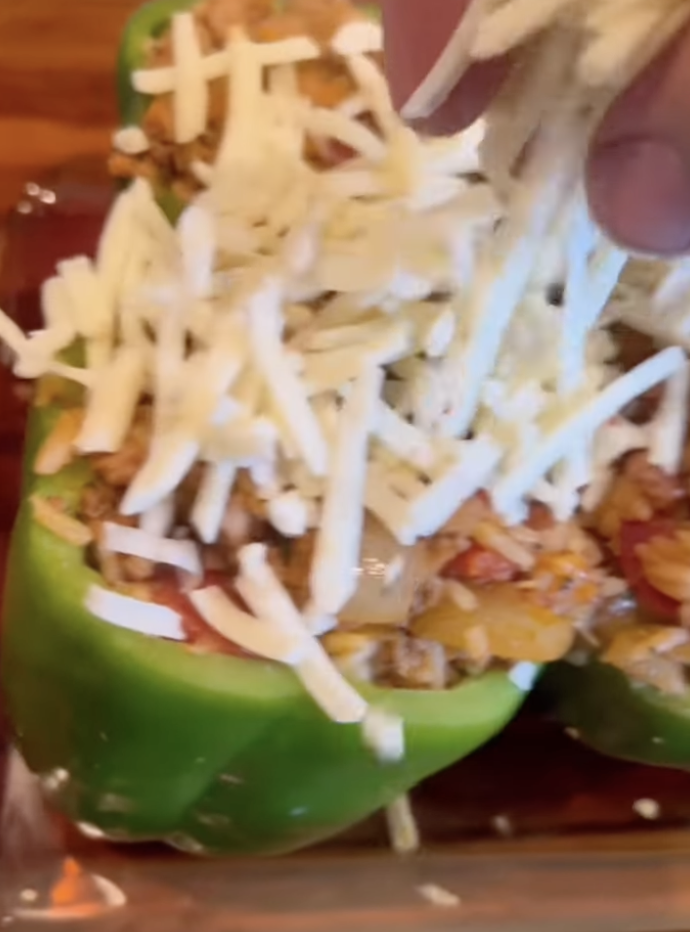 adding cheese to peppers