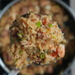 jambalaya in a pot on a ladle