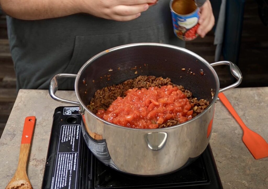pot with meat and diced tomatoes
