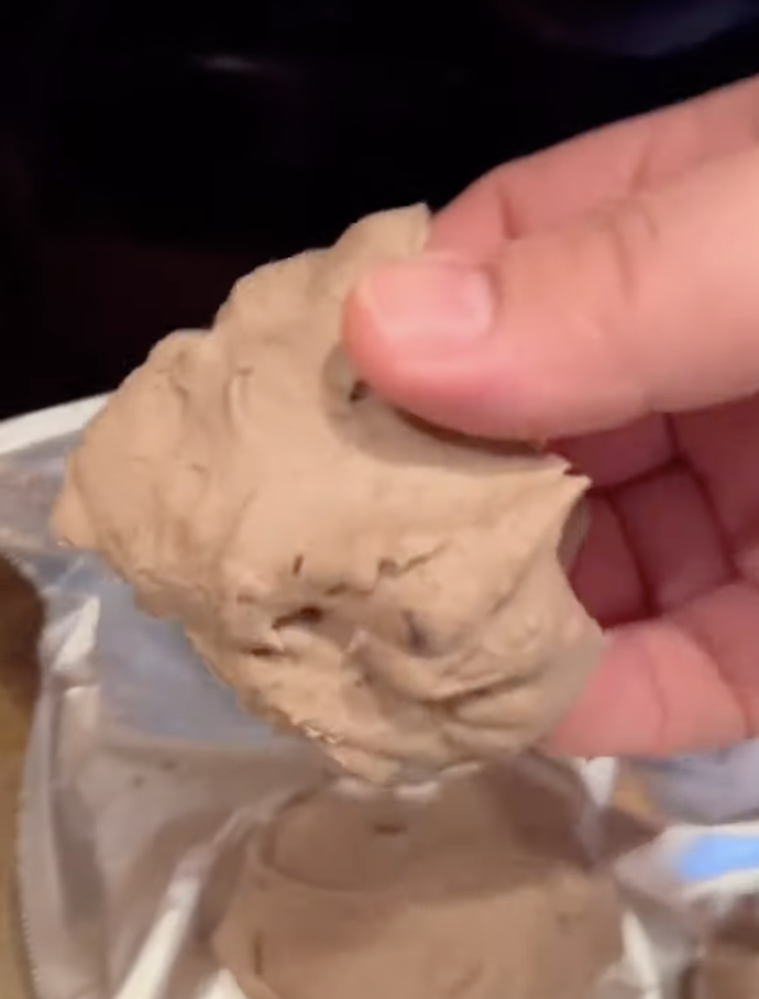 frozen cheesecake bite before dipping in chocolate