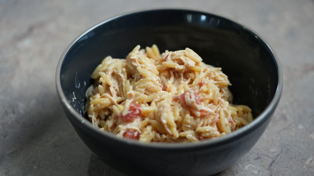 bowl of crockpot creamy cajun chicken orzo