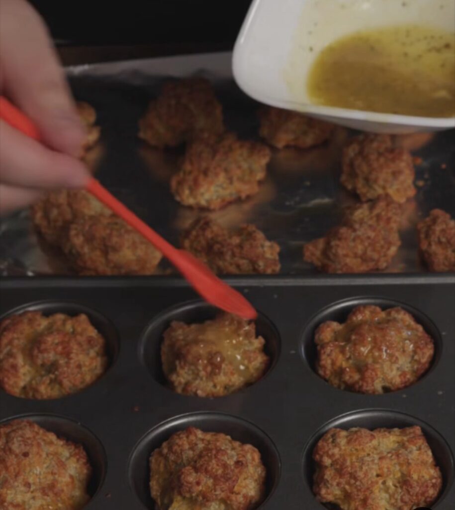 brushing butter of sausage balls