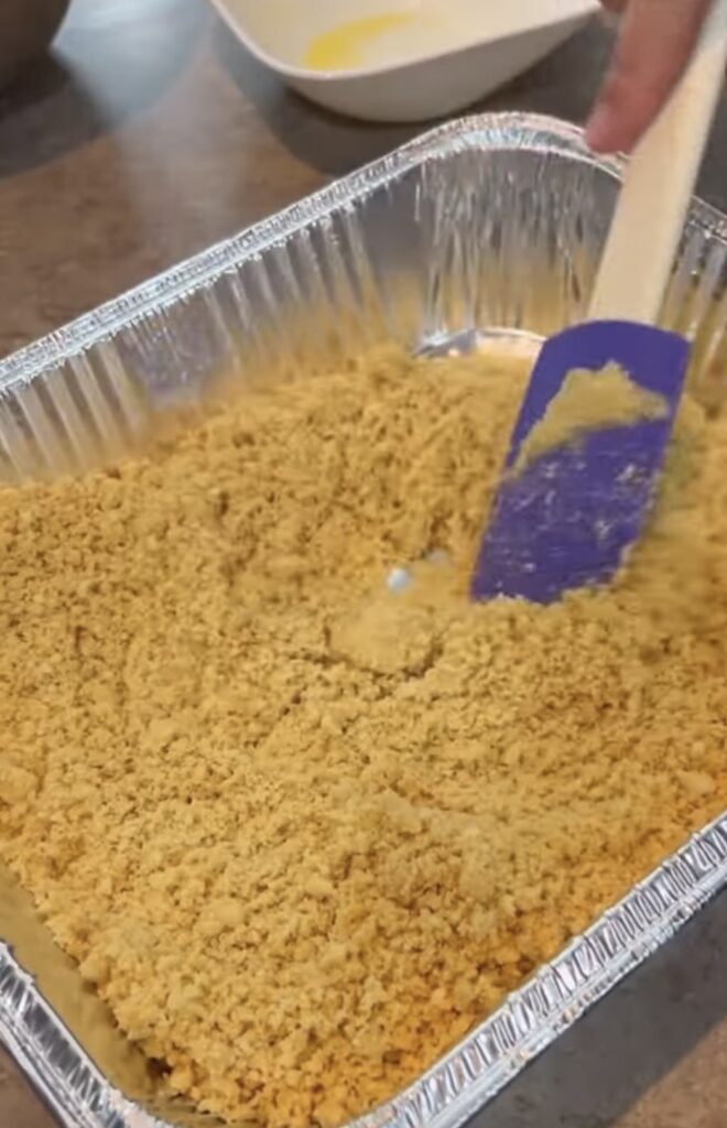 Patting down blended up Oreos to make a crust