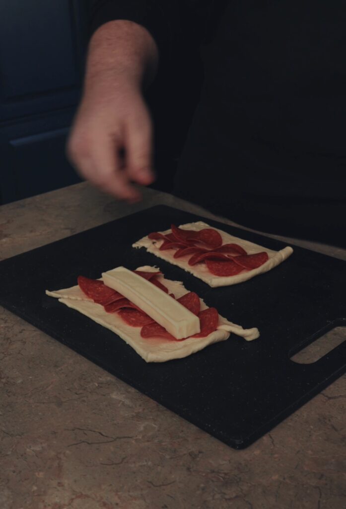 adding mozzarella to dough