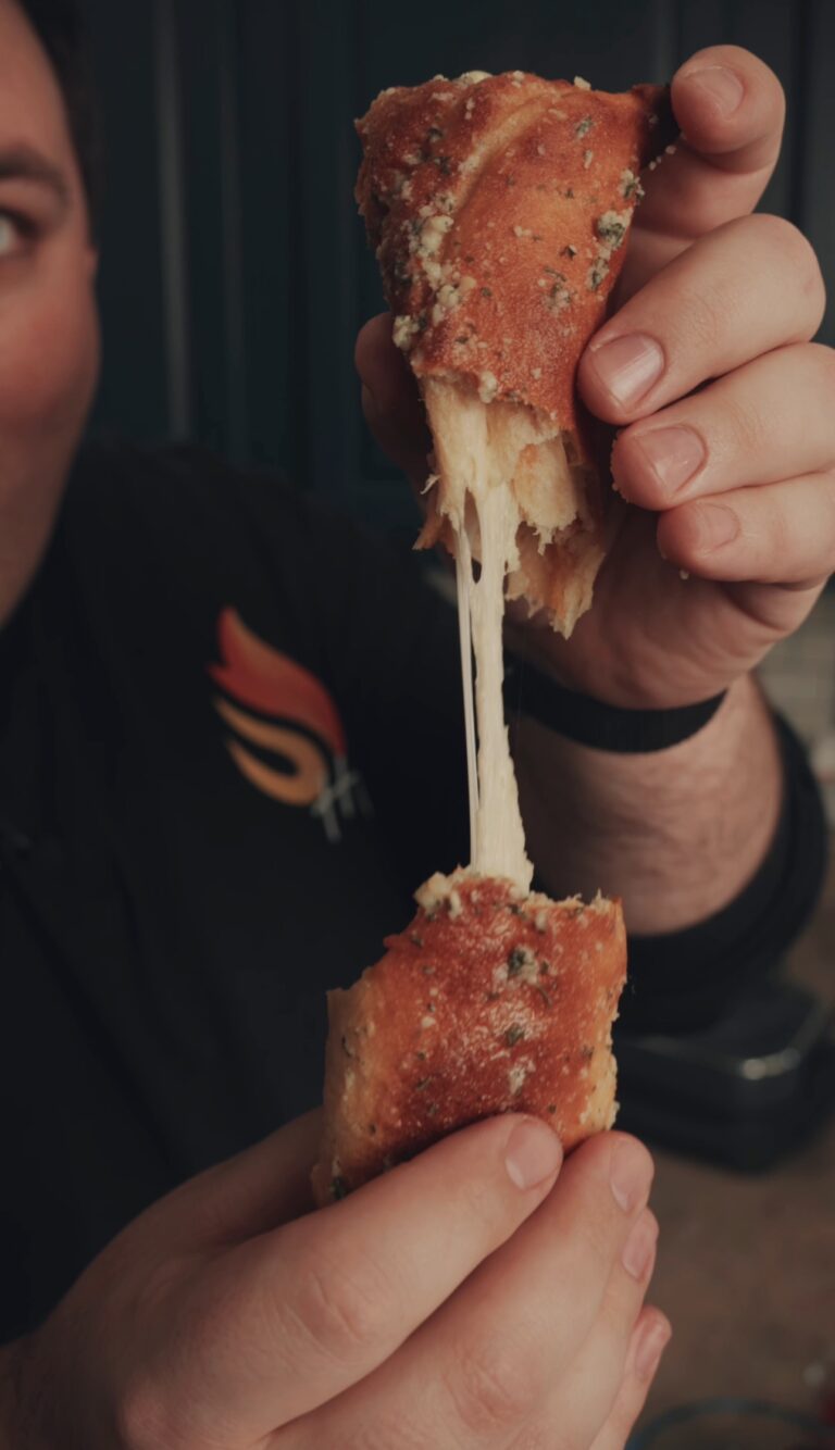 cheesy pizza stuffer being pulled apart to see the cheese