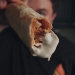 Justin holding a taquito