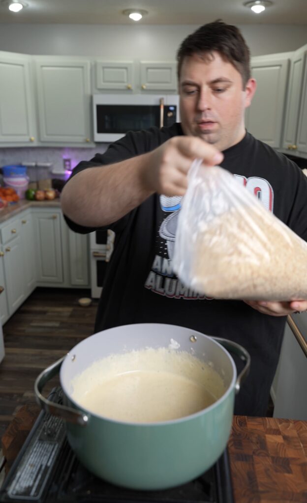 Justin adding rice crispy cereal to pot