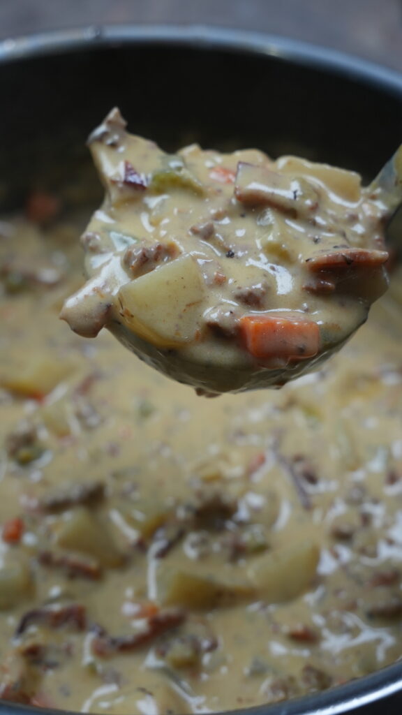 ladle with cheeseburger soup 