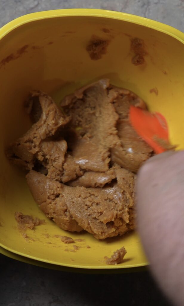 mixing ingredients in yellow bowl