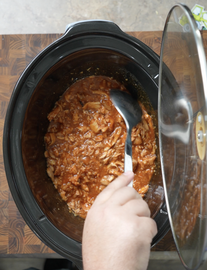 mixing the chicken after shredding