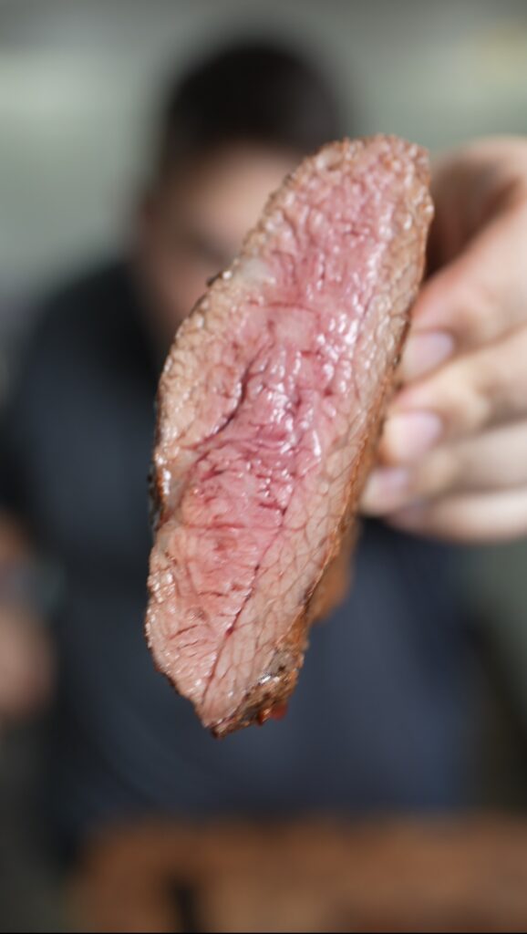 Justin holding steak cut