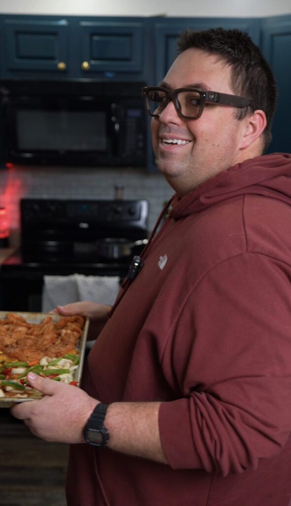Justin holding a pan of food