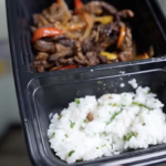 meal prep container of steak fajitas and rice