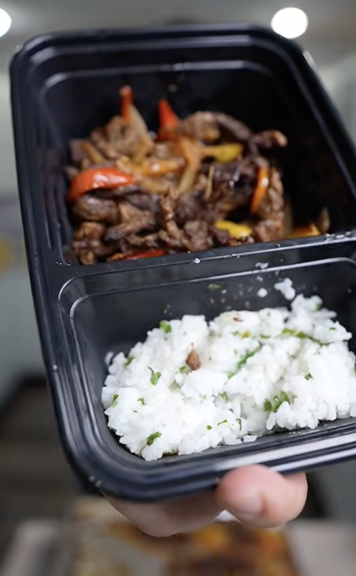 meal prep container of steak fajitas and rice
