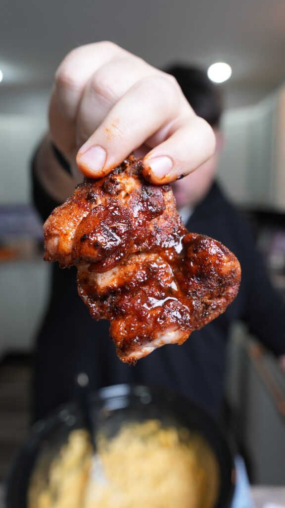 holding up chicken to the camera